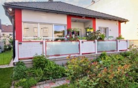 Ferienwohnung Bucur-Ata, © Stadtgemeinde Gloggnitz grau rotes Haus mit Balkon und Blumen