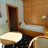 Einzelzimmer, © Sporthotel Semmering Einzelzimmer mit Bett, Sofa, Tisch und Fernseher.